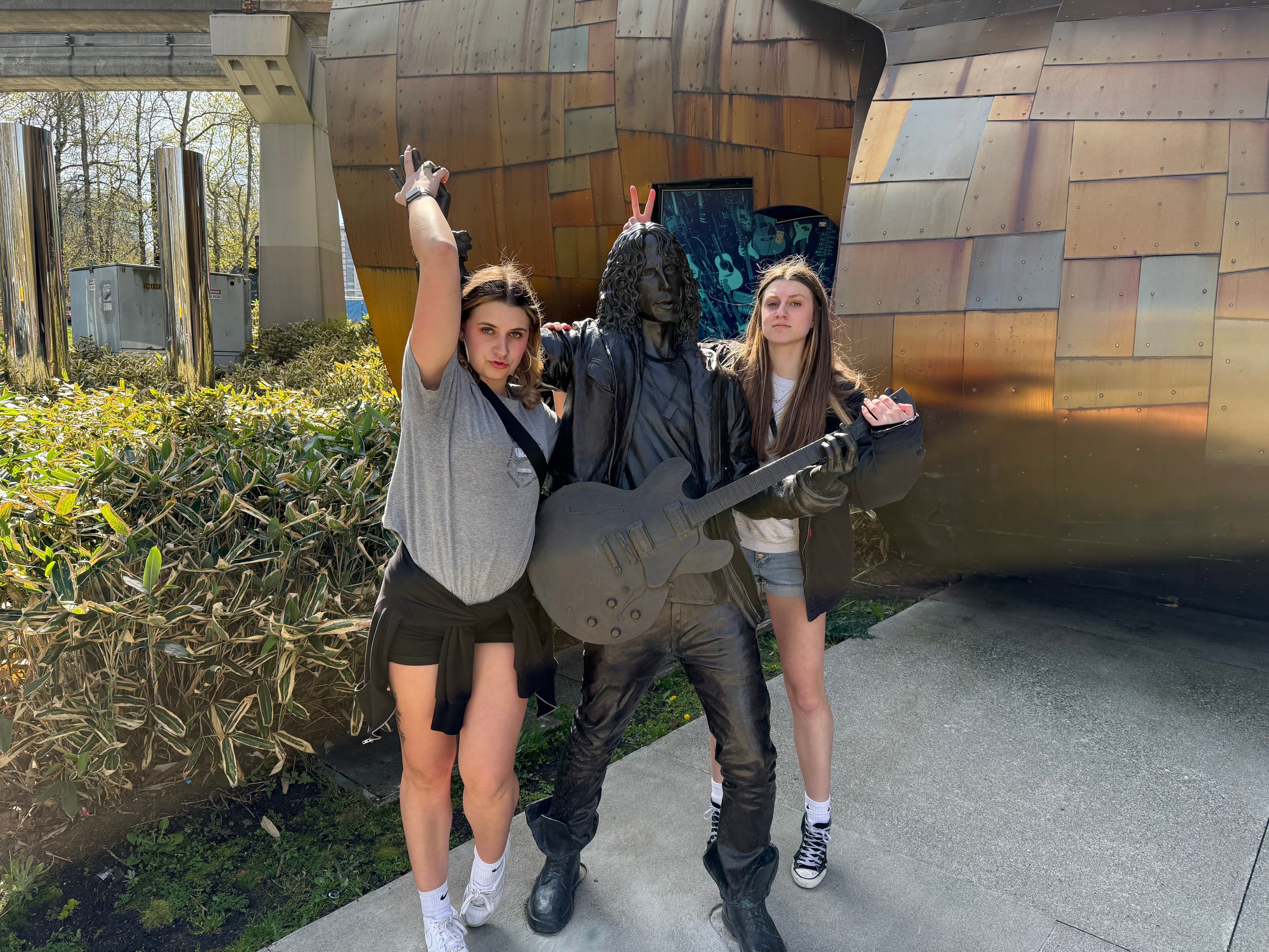Addie and Paytan posing with musician statue